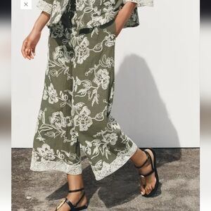 EMBROIDERED TROUSERS WITH GUIPURE HEM.